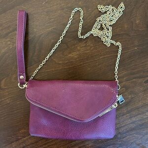Burgundy Urban Expression Crossbody Vegan leather clutch purse gold detail.